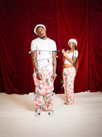 a man and a woman dressed in christmas pajamas